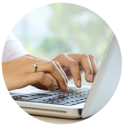 Photo of hands typing on a laptop