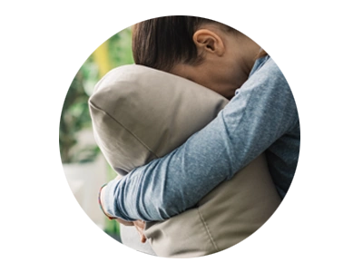 Photo of woman burying face in pillow