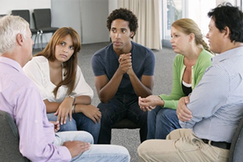 Photo of group of people sitting in a circle