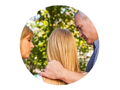 Photo of parents consoling teen daughter